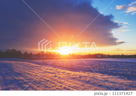 Rural landscape in winter. The snow-covered field at sunset 111371427