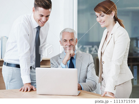 Laptop, portrait and manager with business people in office for corporate legal project meeting. Discussion, technology and professional team of lawyers work on computer by desk together in workplace 111371559