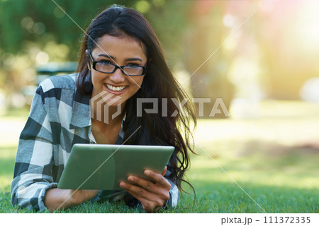 College, woman and portrait with tablet in park for research, project or learning outdoor on campus. University, student and girl streaming online with ebook, education or studying on grass in garden College, woman and portrait with tablet in park for research, project or learning outdoor on campus. University, student and girl streaming online with ebook, education or studying on grass in garden 111372335