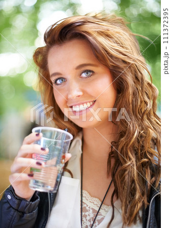 Portrait, smile and woman with drink at music festival, bokeh or celebration outdoor. Face, happy or girl with beverage at party, alcohol and beauty of young female person on summer holiday in France 111372395