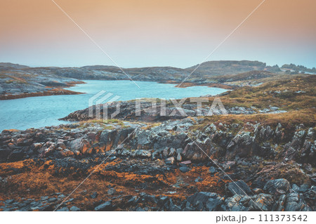 Rocky seashore with cloudy sky. Wilderness. Beautiful nature of Norway. Lofoten islands 111373542
