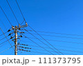 晴れた日の青空と電信柱 111373795