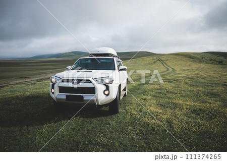 Tibet,China - June 13,2023 ,Driving Toyota off road car on the high altitude grassland mountains 111374265