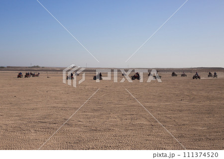 Group of tourists on ATVs on safari road 111374520