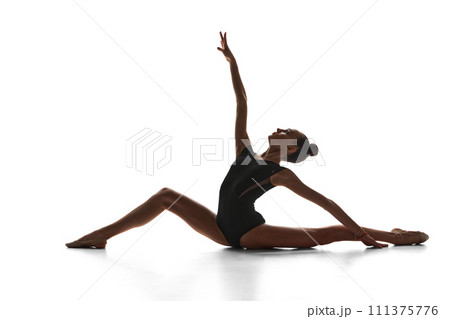 Talent show. Artistic, beautiful, elegant teen girl rhythmic gymnast performing against white studio background Talent show. Artistic, beautiful, elegant teen girl rhythmic gymnast performing against white studio background 111375776