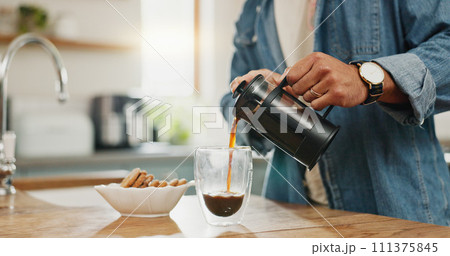 Hands, pouring coffee and breakfast in home kitchen, energy and start morning with warm matcha at table. Man, filter kettle and french press plunger for fresh organic caffeine at house for hot drink 111375845
