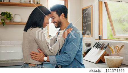Love, hug and couple in a kitchen happy, together and intimate while bonding in their home. Embrace, romance and man with woman hugging, smile and sharing moment of trust, care or soulmate connection 111375863