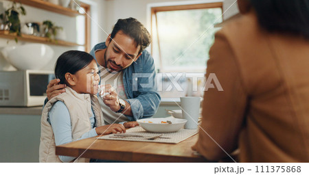 Parents, children and a girl eating spaghetti with her family in the dining room of their home together for supper. Food, kids and father around a table for a meal, bonding over dinner in a house 111375868