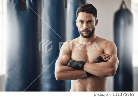 Fitness, boxer and gym of a man in sports professional for strength and motivation with arms crossed. Portrait of a male in strong and confident boxing at health club by punching bag after training 111375968
