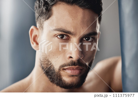 Portrait of muscular man in gym after fitness, exercise or workout and looking serious. Strong athlete cardio exercise, muscle power from sports and professional fight competition looking focused Portrait of muscular man in gym after fitness, exercise or workout and looking serious. Strong athlete cardio exercise, muscle power from sports and professional fight competition looking focused 111375977