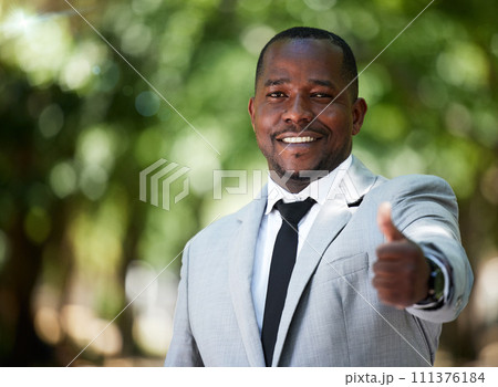 Portrait, smile and happy businessman with thumbs up for achievement, goal and success in his corporate job while outdoor in a park. Employee with hand sign or icon for thank you, winner and vote 111376184