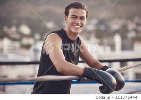 Boxing ring, gloves and man portrait for fitness vision, motivation or a happy workout training outdoor. Smile of young boxer in mma wrestling sports for wellness exercise, health and strong muscles 111376444
