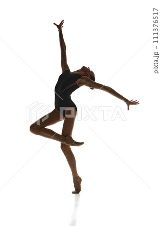 Full-length image of talented, artistic teen girl, rhythmic gymnast in stage costume performing against white studio background Full-length image of talented, artistic teen girl, rhythmic gymnast in stage costume performing against white studio background 111376517