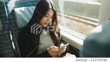 Japan woman, travel and train on smartphone, social media and public transportation on metro bullet. Person, cellphone and online on fast vehicle for weekend trip and commute in tokyo for adventure 111378782