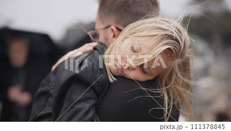 Sad, death and a daughter with her father at a funeral for grief or mourning loss together outdoor. Family, empathy and a man holding his girl child at a memorial service or ceremony for condolences Sad, death and a daughter with her father at a funeral for grief or mourning loss together outdoor. Family, empathy and a man holding his girl child at a memorial service or ceremony for condolences 111378845