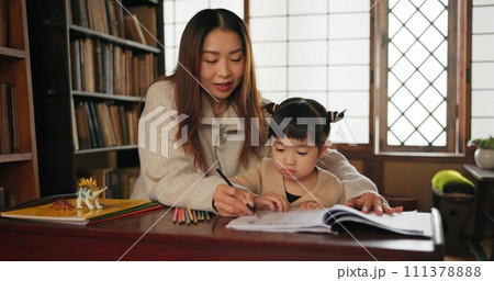 Child, mother and teaching education for home school or drawing in Japanese, learning or development. Female person, girl daughter and pencil project in Tokyo or art book lesson, studying or creative 111378888