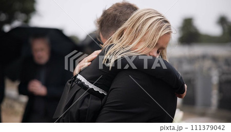 Sad, death and a girl with her father at a funeral for grief or mourning loss together outdoor. Family, empathy and a man holding his daughter at a memorial service or ceremony for condolences Sad, death and a girl with her father at a funeral for grief or mourning loss together outdoor. Family, empathy and a man holding his daughter at a memorial service or ceremony for condolences 111379042