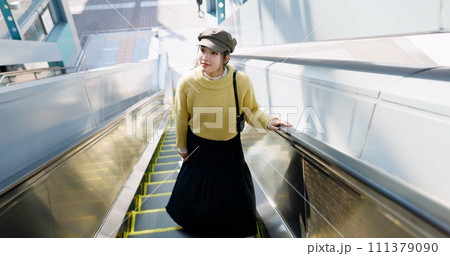 Woman, escalator and Japanese travel or journey destination booking, airport or holiday. Female person, Tokyo and passenger or boarding international flight or adventure explore, vacation or tour 111379090