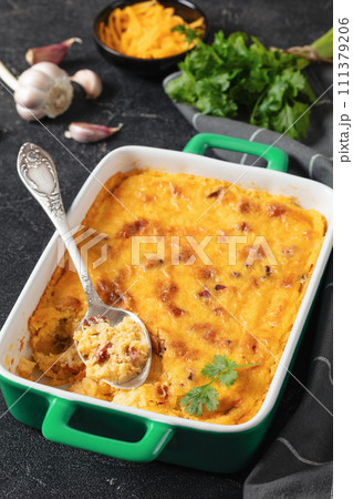 cheesy smoked sausage grits bake in ceramic dish cheesy smoked sausage grits bake in ceramic dish 111379206