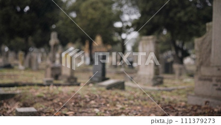 Graveyard, burial and tombstone in cemetery for death ceremony, funeral ritual and memorial service. Headstone, rip and resting place of departed for mourning, loss and remembrance of dead by church Graveyard, burial and tombstone in cemetery for death ceremony, funeral ritual and memorial service. Headstone, rip and resting place of departed for mourning, loss and remembrance of dead by church 111379273