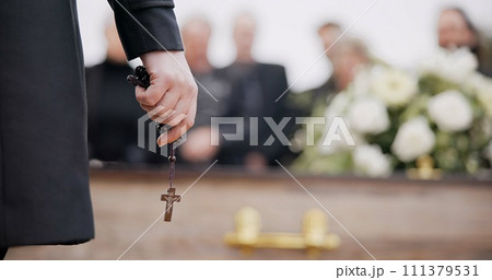 Funeral, religion and hands with rosary for memorial service, death ceremony and obituary sermon. Christianity, burial and closeup of pastor or priest with religious symbol for gospel, faith and loss 111379531
