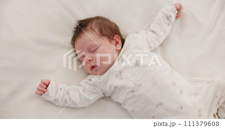 Cute, sleeping and newborn baby on a bed at a home in the bedroom for resting and dreaming. Tired, sweet and top view of infant, child or kid taking a nap in the morning in nursery at family house. Cute, sleeping and newborn baby on a bed at a home in the bedroom for resting and dreaming. Tired, sweet and top view of infant, child or kid taking a nap in the morning in nursery at family house. 111379608