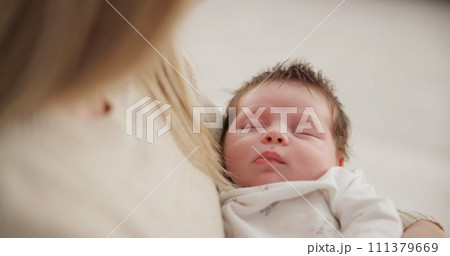 Parent, love and baby in arms of mother for bonding, relationship and child development in family home. Newborn, motherhood and mom carry infant for dreaming, support and sleeping in nursery room 111379669