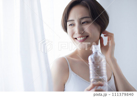 水を飲んでリラックスする若い女性 111379840
