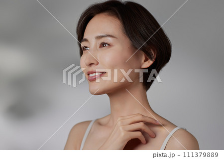光と影の背景で撮影をした若い女性のスキンケアイメージ 111379889