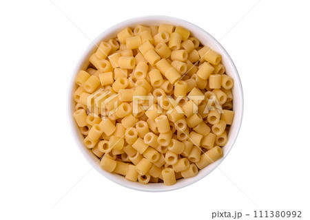 Raw ditali pasta made from durum wheat on a dark concrete background Raw ditali pasta made from durum wheat on a dark concrete background 111380992