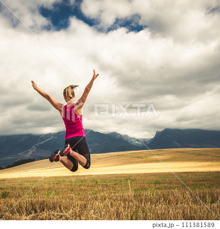 Young woman jumping in the mountains Young woman jumping in the mountains 111381589