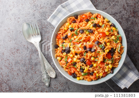 Spanish, Mexican tomato spicy rice with beans close-up in a bowl. Horizontal top view 111381803