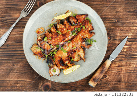 Fried mackerel on a wooden background. 111382533