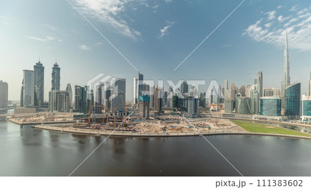 Aerial view to Dubai Business Bay and Downtown with the various skyscrapers and towers timelapse 111383602