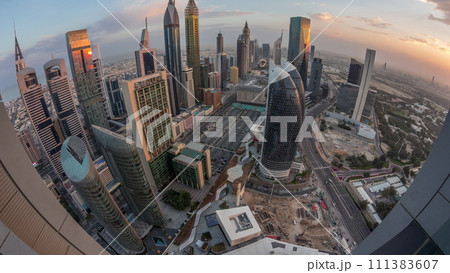 Skyline panorama of the high-rise buildings on Sheikh Zayed Road in Dubai aerial night to day timelapse, UAE. 111383607