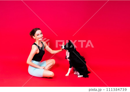 Beautiful sport female with border collie in studio Beautiful sport female with border collie in studio 111384739