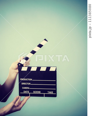 Woman holding professional film slate 111385080