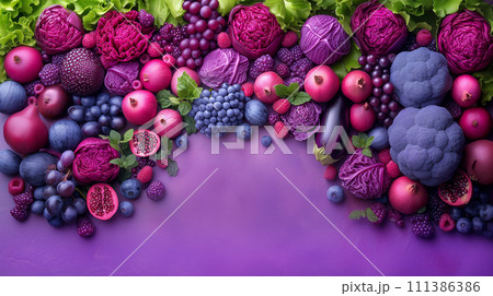 Purple composition. Background bright fruits and vegetables apples, grapes, greens, blueberries, eggplant, figs, cabbage, pomegranate, blackberry on purple background. Copy space. Purple composition. Background bright fruits and vegetables apples, grapes, greens, blueberries, eggplant, figs, cabbage, pomegranate, blackberry on purple background. Copy space. 111386386