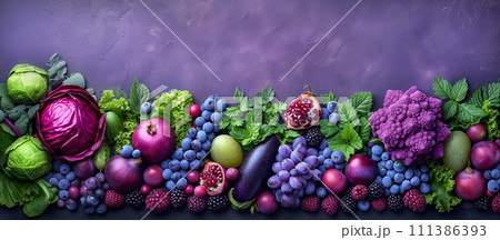 Purple composition. Background bright fruits and vegetables apples, grapes, greens, blueberries, eggplant, figs, cabbage, pomegranate, blackberry on purple background. Copy space. 111386393