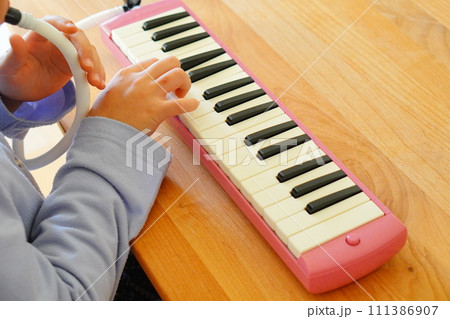 小学4年生の女の子が鍵盤ハーモニカを演奏している様子。 111386907