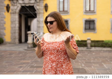 Caucasian 30s woman in sunglasses holding mobile phone and reading unpleasant sms awful news feel indignant. Bad notice from bank blocked account broken smartphone, shock astonishment 111389359
