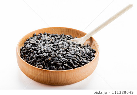 dried grains bird food. Black sunflower seeds in pot. 111389645
