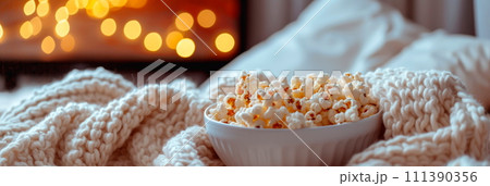 A cozy movie night at home with a selection of classic romantic films and white appetizers. 111390356