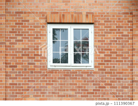 Classic white windows on brick wall facade. 111390367