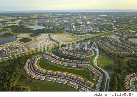 View from above of densely built residential houses under construction in closed living clubs in south Florida. American dream homes as example of real estate development in US suburbs 111390687