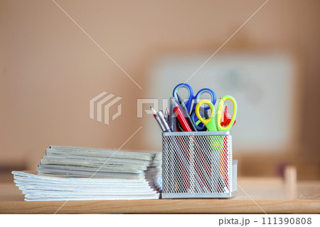 Stack of notebooks and stationery arrangement in classroom or office on copy space background Stack of notebooks and stationery arrangement in classroom or office on copy space background 111390808