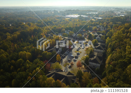 View from above of apartment residential condos between yellow fall trees in suburban area in South Carolina. American homes as example of real estate development in US suburbs View from above of apartment residential condos between yellow fall trees in suburban area in South Carolina. American homes as example of real estate development in US suburbs 111391528