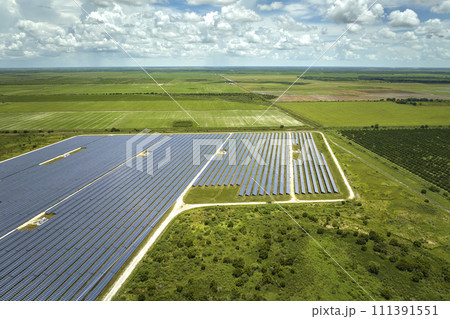 Aerial view of large sustainable electrical power plant with rows of solar photovoltaic panels for producing clean electric energy. Concept of renewable electricity with zero emission 111391551