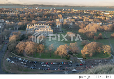 Aerial view of Palace of Holyroodhouse and Holyrood Park seen from the top of Salisbury Crags. Aerial view of Palace of Holyroodhouse and Holyrood Park seen from the top of Salisbury Crags. 111392161