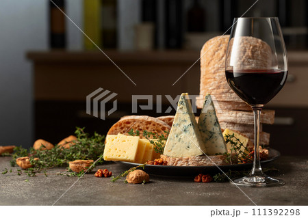Cheese, bread, walnuts, and thyme on a kitchen table. Cheese, bread, walnuts, and thyme on a kitchen table. 111392298